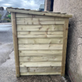 Angus Logs - Giant Log Store closed side panel showing overlapped feather edge board cladding and sloped roof, positioned against a wall